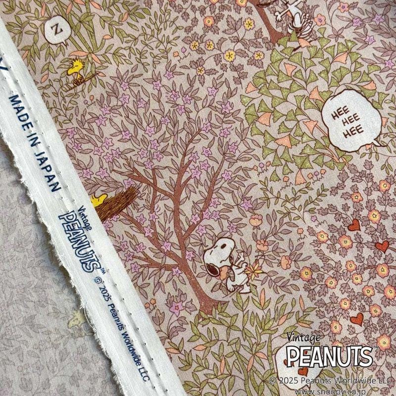 a close-up view of a fabric with a floral pattern and illustrations of characters from the Peanuts comic strip.