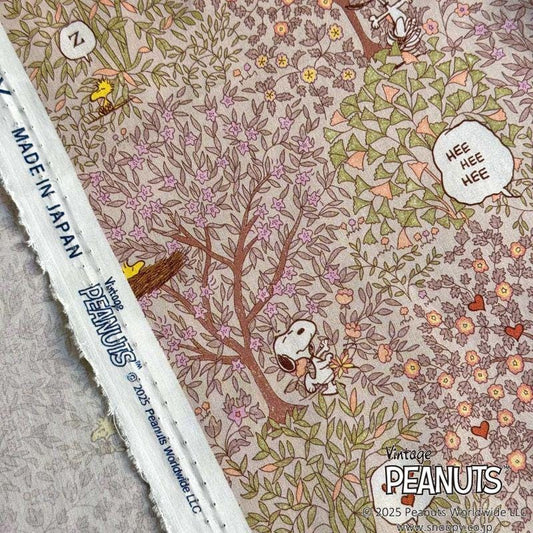 a close-up view of a fabric with a floral pattern and illustrations of characters from the Peanuts comic strip.