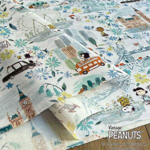 The image is a collage of various cartoon-style illustrations, including Peanuts characters, city scenes, and other whimsical elements. The collage is spread across a large surface area, with the text "Vintage Peanuts" visible in the bottom right corner.