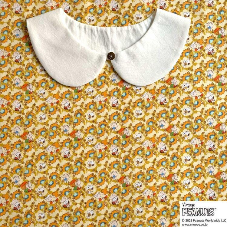 A white collar is displayed against a background with a repeating pattern of colorful cartoon characters.