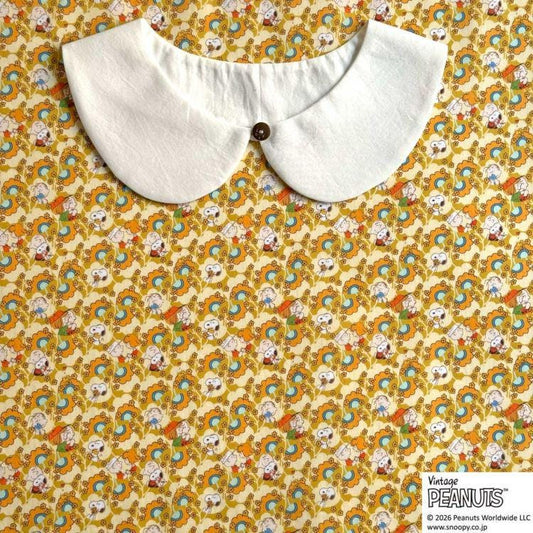 A white collar is displayed against a background with a repeating pattern of colorful cartoon characters.