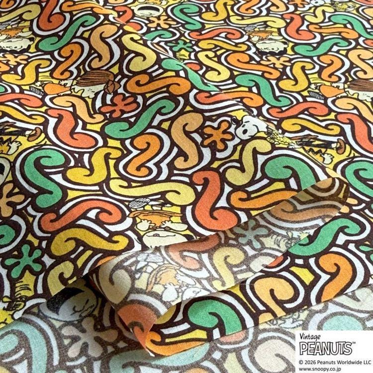 a vibrant and colorful pattern with various shapes and designs, including swirls, flowers, and other abstract elements. The pattern appears to be a repeating design, creating a visually striking and dynamic composition.
