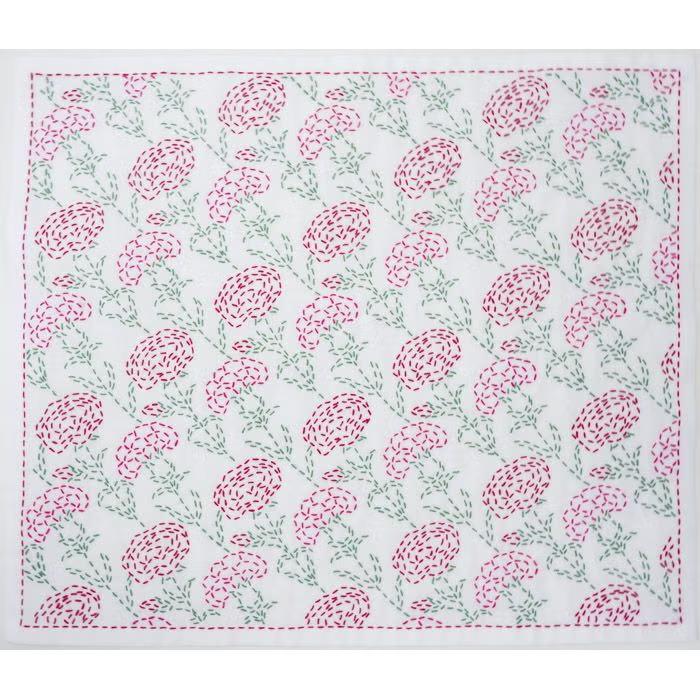 a square-shaped white fabric with a repeating floral pattern in shades of pink and green. The pattern consists of various flowers and leaves, creating a visually appealing and intricate design.
