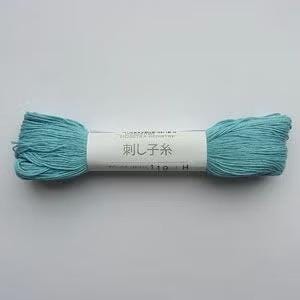A spool of blue yarn with a label in Japanese characters.
