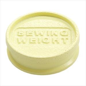 A yellow object with the text "SEwing WEIGHT" embossed on it.