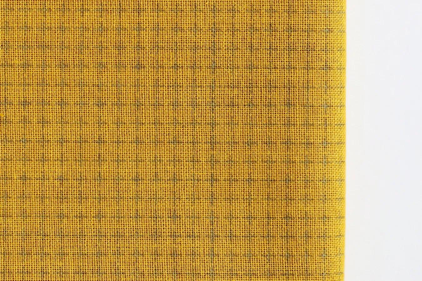 a close-up view of a fabric with a yellow and black checkered pattern.