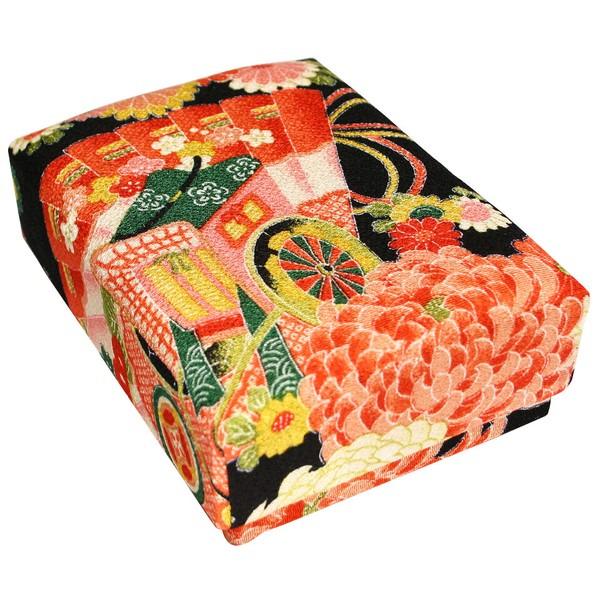 a box with a vibrant, colorful, and intricate design, including a variety of flowers and patterns in shades of red, green, and yellow.