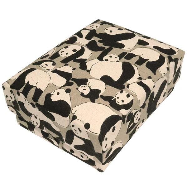 a square-shaped box with a repeating pattern of black and white panda illustrations.