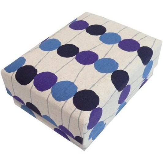 a rectangular box with a pattern of blue and purple circles on a beige background.