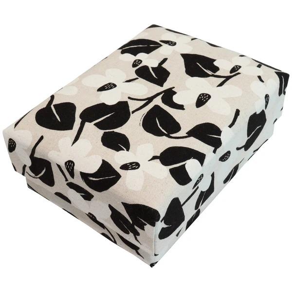 A square-shaped box with a black and white floral pattern on its surface.