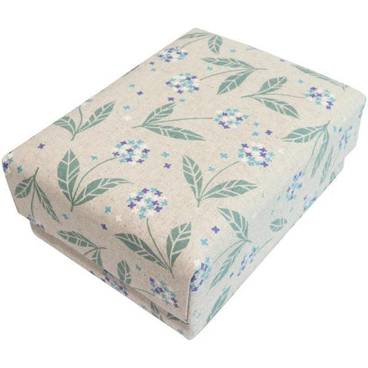 a rectangular box with a floral pattern on it, featuring green leaves and purple flowers.