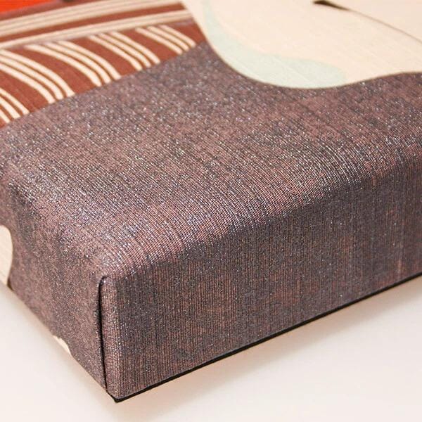 a close-up view of a textured fabric, possibly a piece of clothing or a textile, with a brown and white striped pattern.