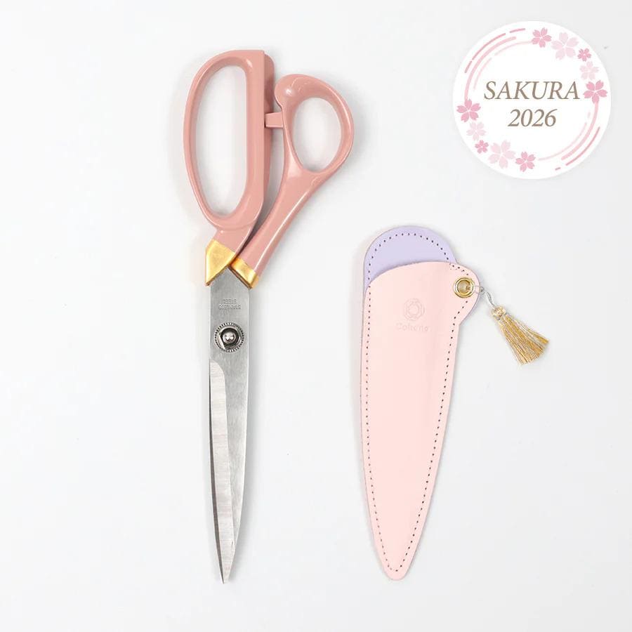 a pair of pink-handled scissors and a pink-covered leather scissor case, both placed on a white background.