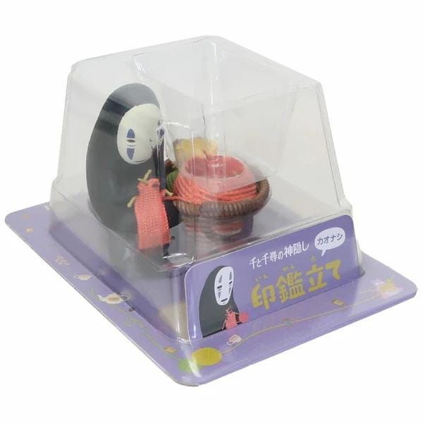 A toy figurine of a character from the animated film "No Face" is displayed in a clear plastic packaging.