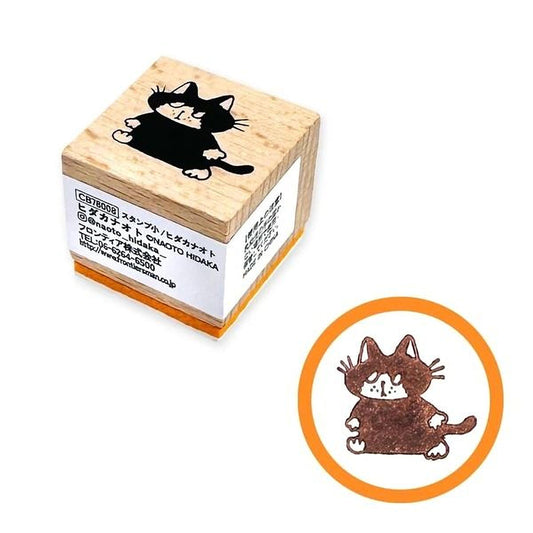 a wooden stamp with a black cat design on it, and there is a circular stamp with a brown cat design on it.