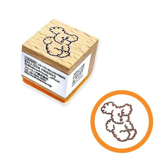 a wooden rubber stamp with a cartoon character on it, and there is a smaller image of the same stamp in the bottom right corner.