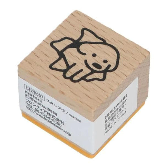 A wooden stamp with a cartoon fish design on it.
