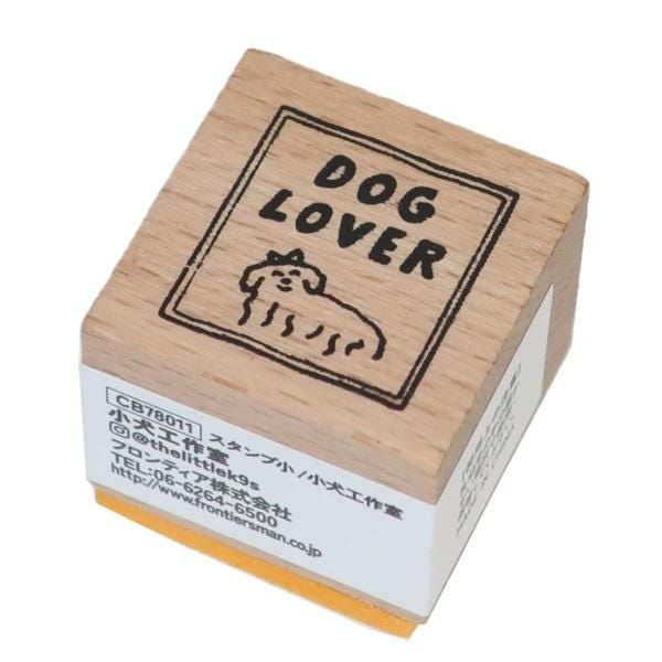A wooden stamp with the text "DOG LOVER" and a small illustration of a dog.