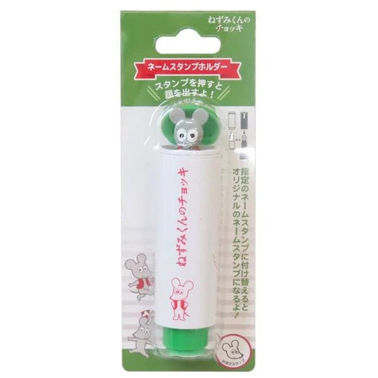 A white and green marker with a small mouse figure on it, along with some Japanese text.