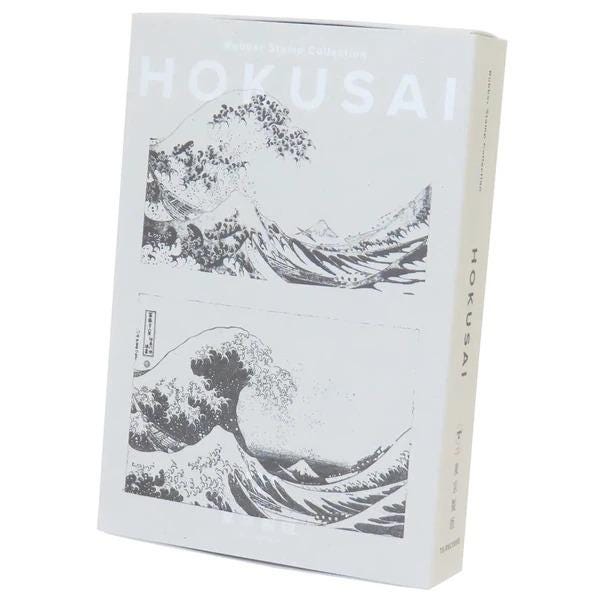 The image is a box containing a collection of artwork, specifically paintings by the artist Hokusai.