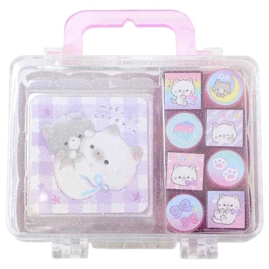 A clear plastic case with a pink handle, containing a collection of colorful cat-themed items such as stickers and a small stuffed animal.