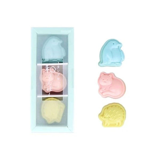a set of four colorful animal figurines, including a penguin, cat, dog, and hedgehog, displayed in a clear plastic container.