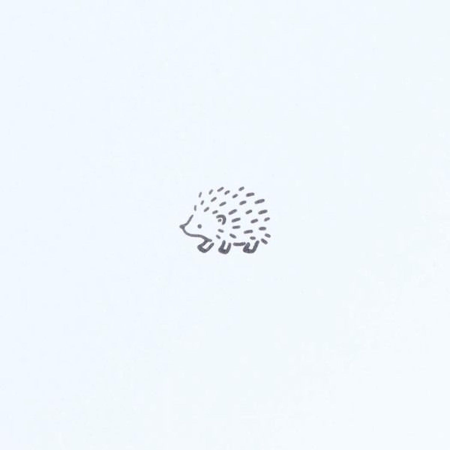 A simple black and white illustration of a hedgehog.