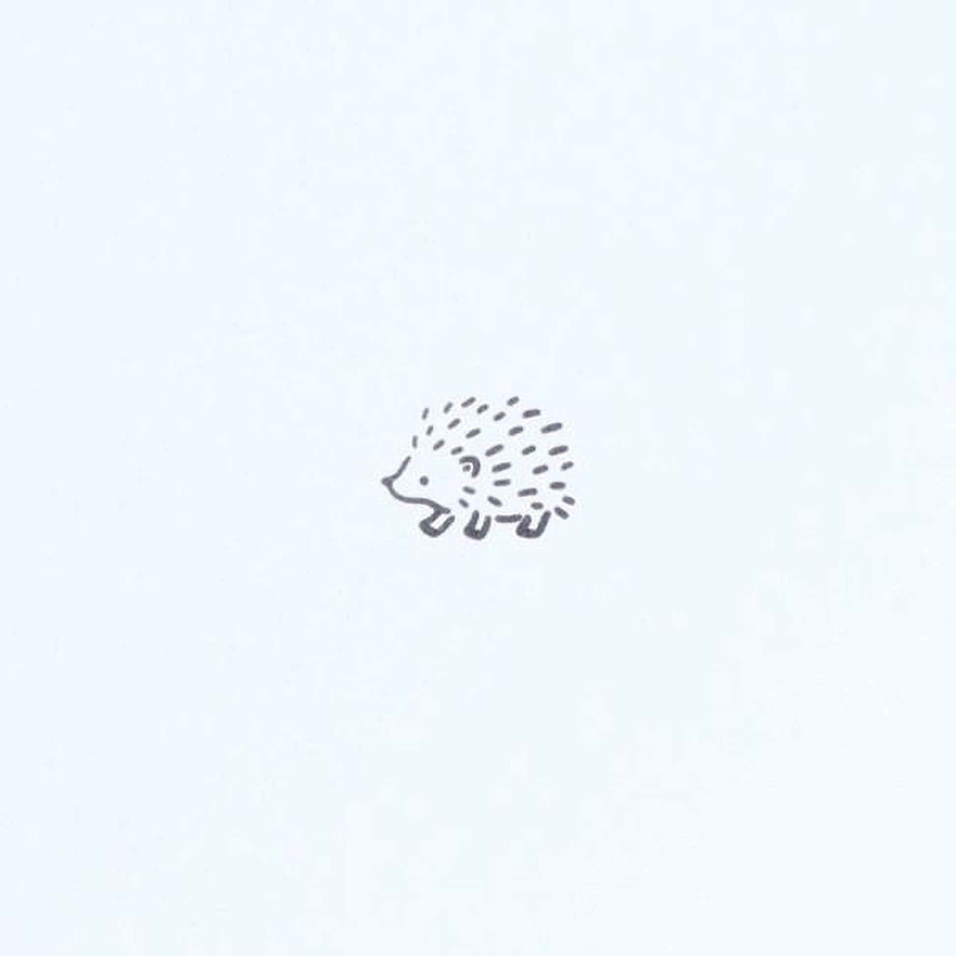 A simple black and white illustration of a hedgehog.