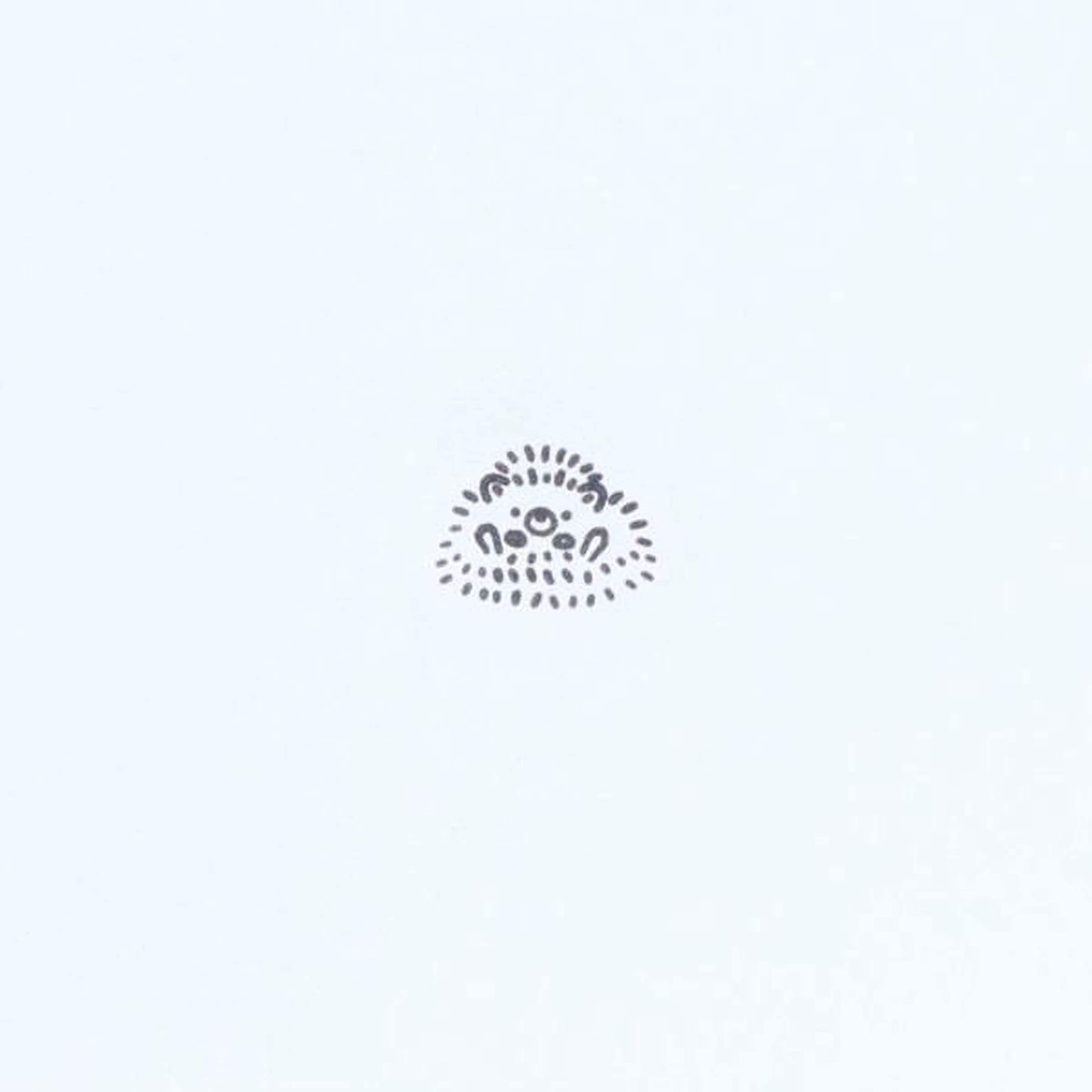 A simple black and white illustration of a hedgehog or similar small animal.