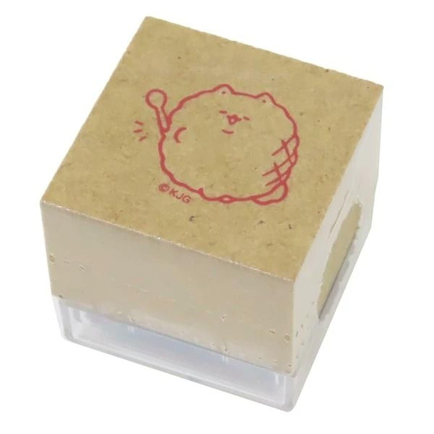 A square rubber stamp with a cartoon character printed on it.
