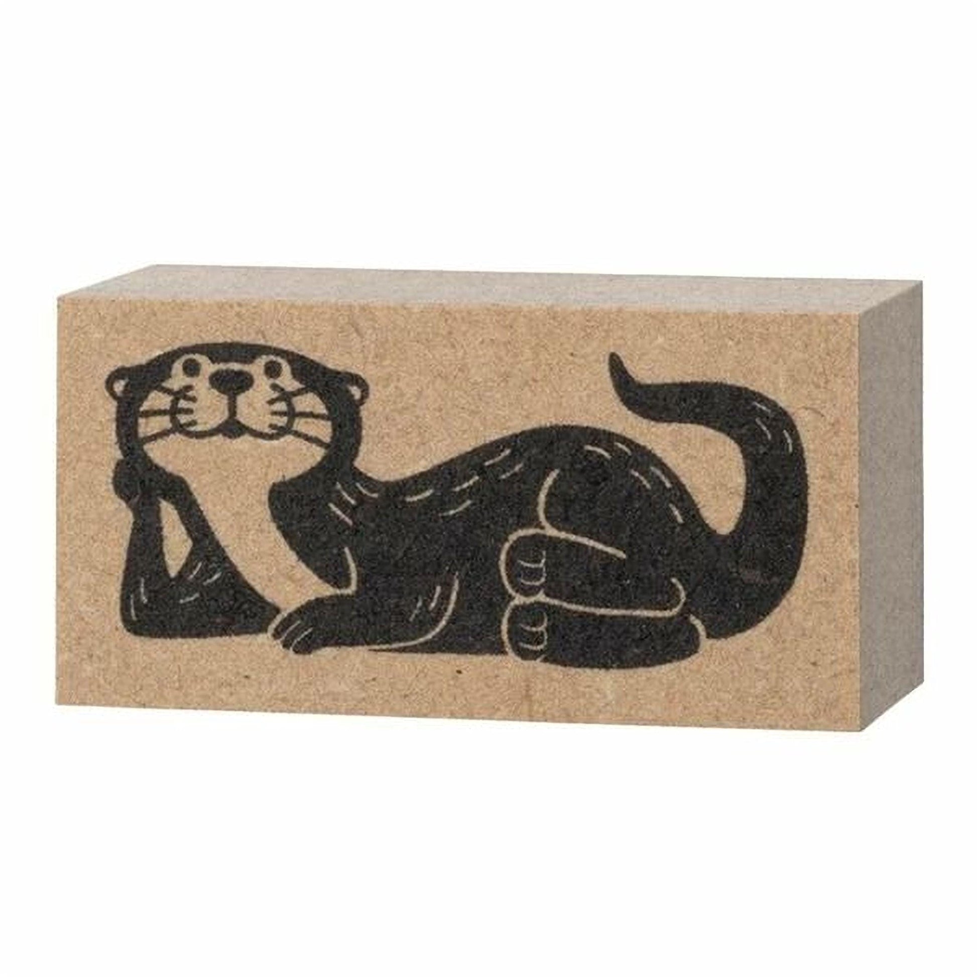 A black and white illustration of an otter on a block of wood.
