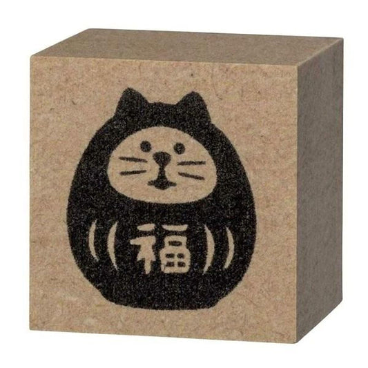 A square block with a black cat design on it.