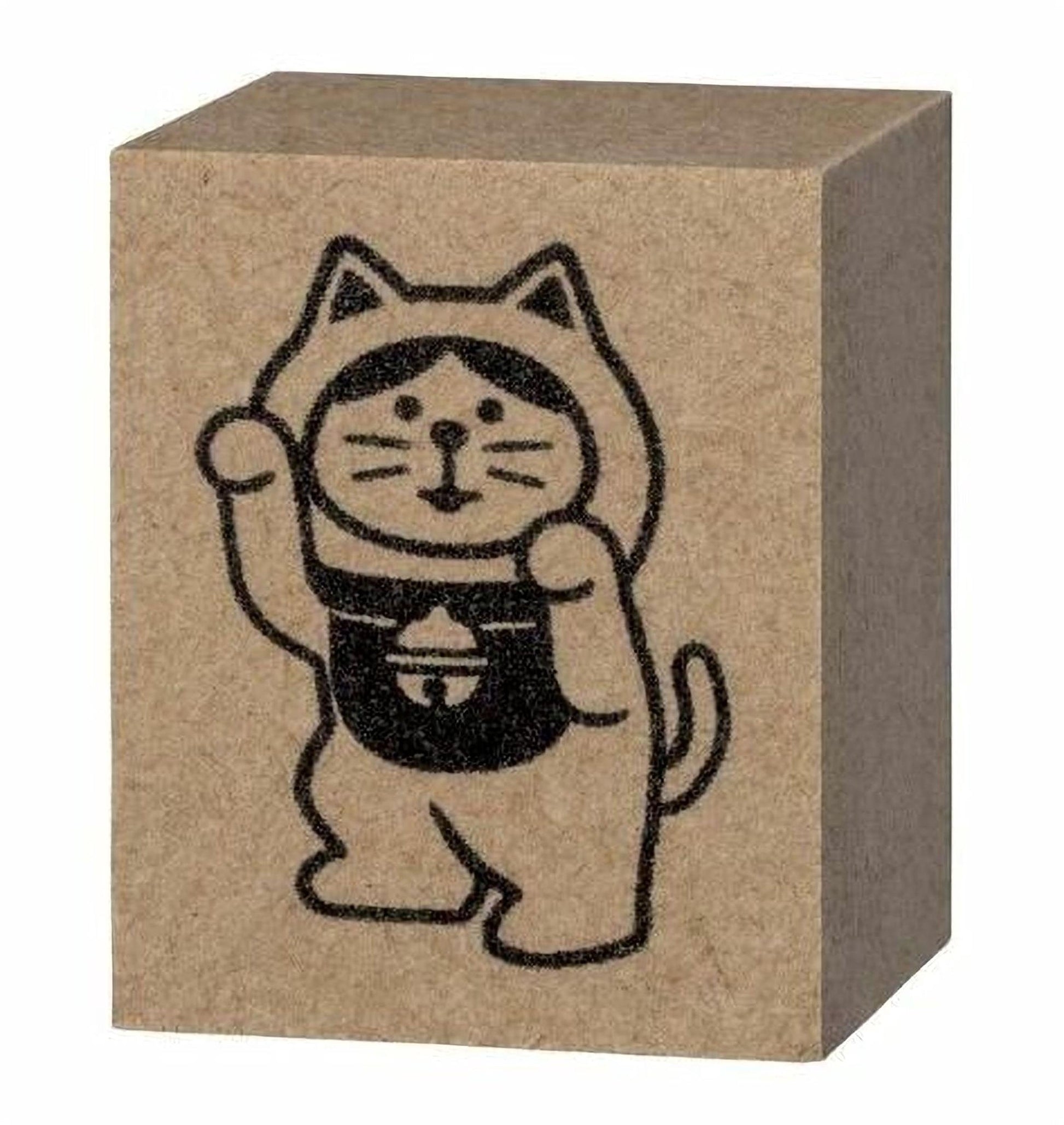 A block of brown cardboard with a black illustration of a cat wearing a hat and holding a bell.