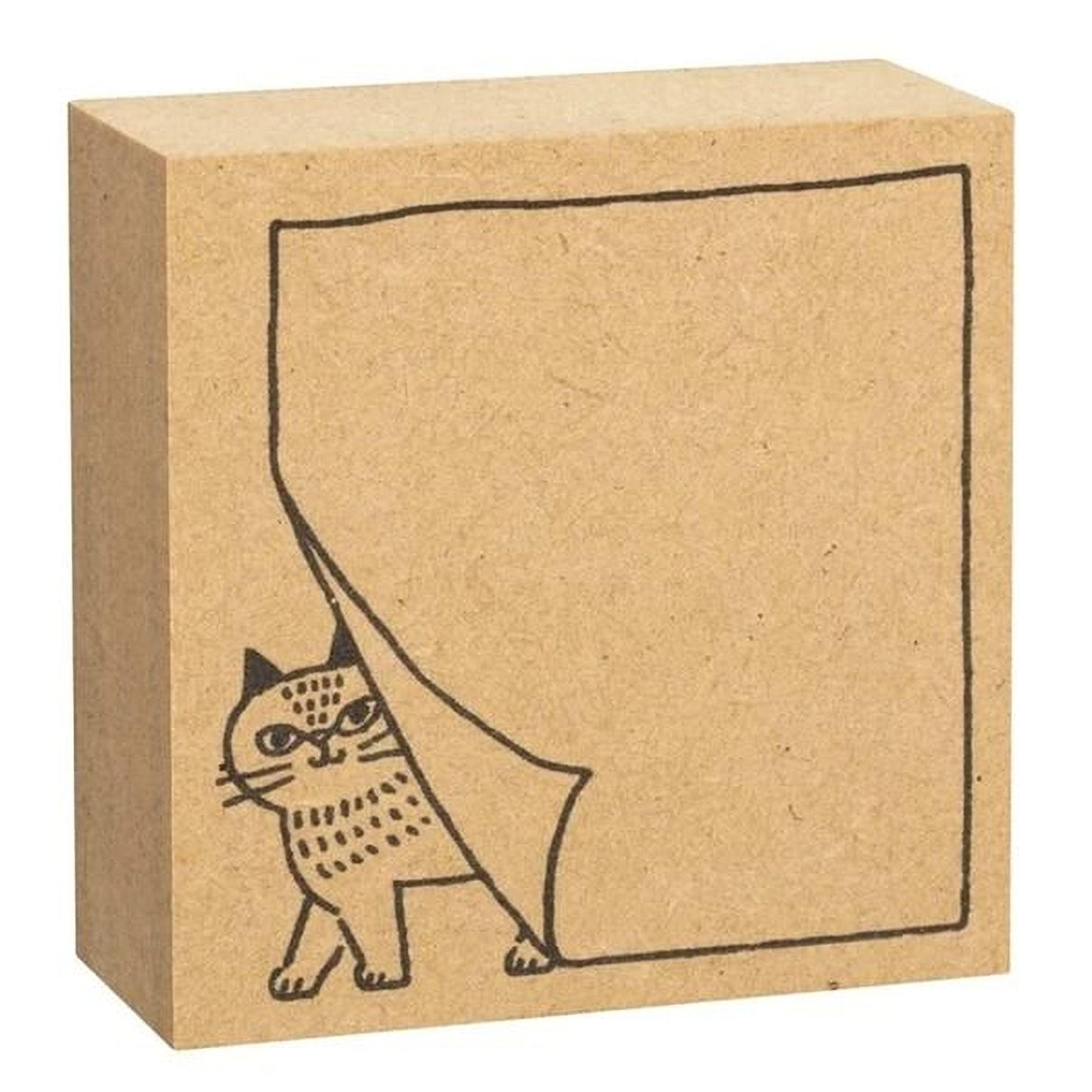 A simple cardboard block with a cat illustration on it.