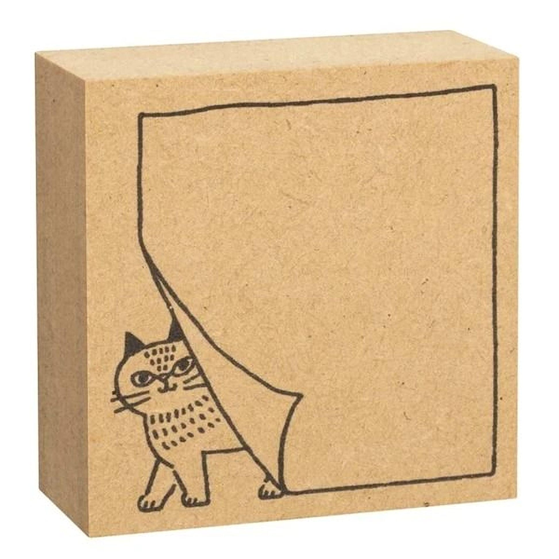 A simple cardboard block with a cat illustration on it.