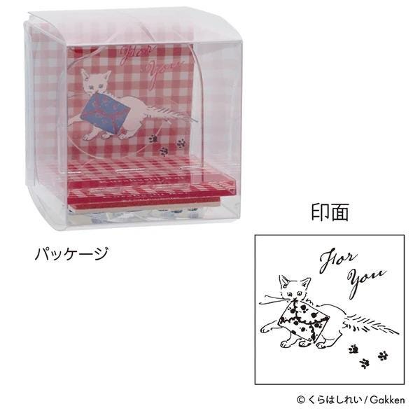 a clear plastic container with a red and white checkered pattern, and a smaller image of a cat wearing a hat and holding a book. The text "おめちゃん" is visible, which is Japanese for "for you".
