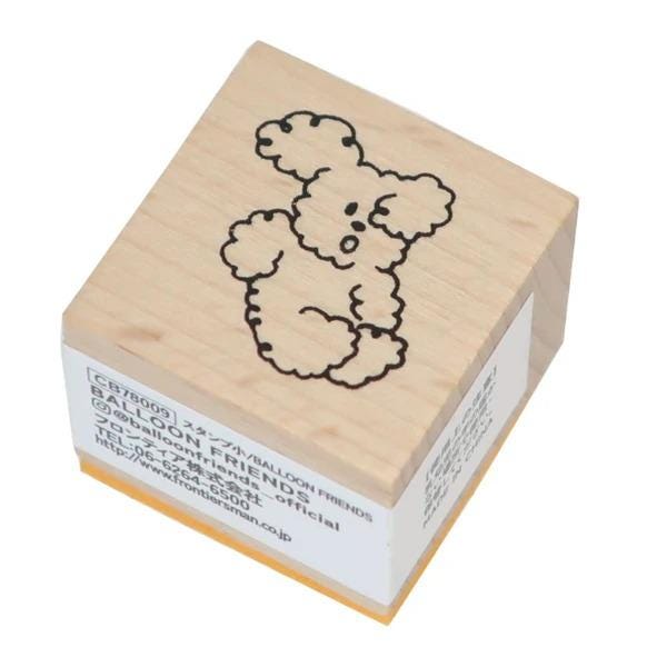 A wooden stamp with a cartoon character on it.