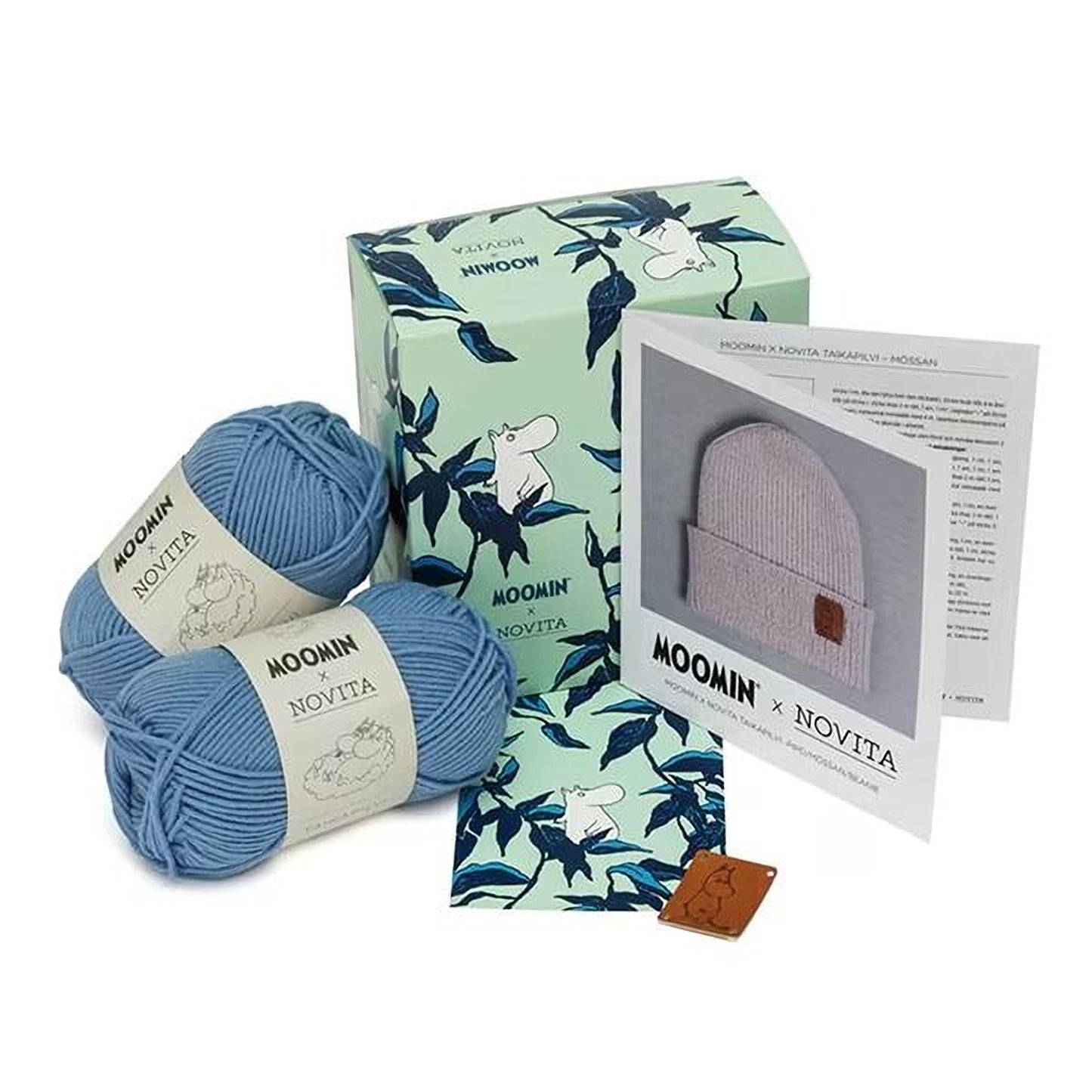 a collection of knitting supplies, including yarn, a box, and a booklet, all with the Moomin brand name.