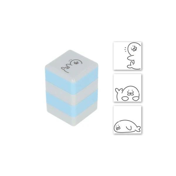 a blue and white cube-shaped object with a cartoon character on it, along with three smaller images depicting cartoon characters.