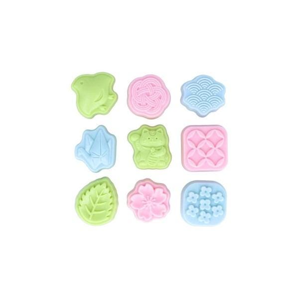 nine colorful, pastel-colored molds or shapes, including a frog, flower, cloud, and other decorative elements, arranged in a 3x3 grid.