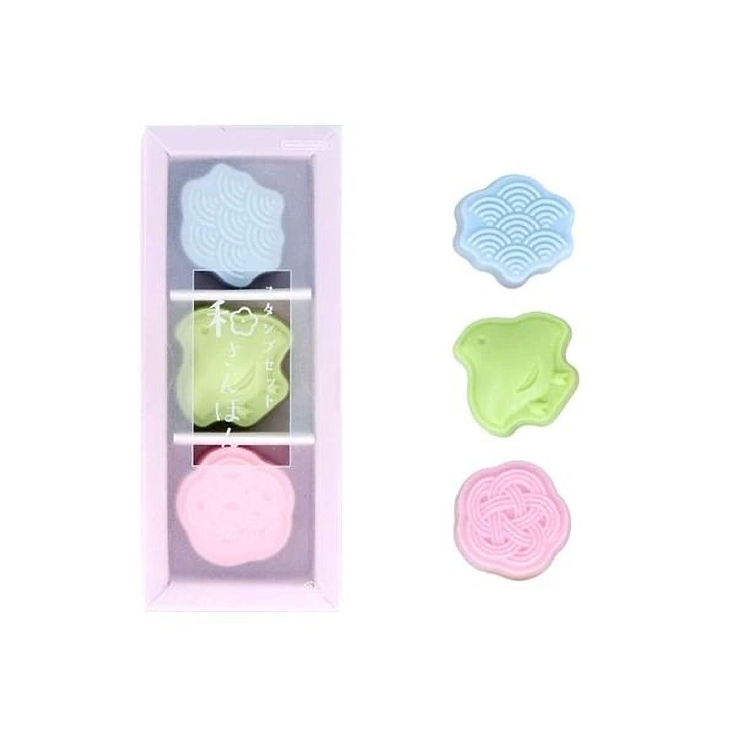 A pink box containing three colorful, round objects with different patterns, and a white background.