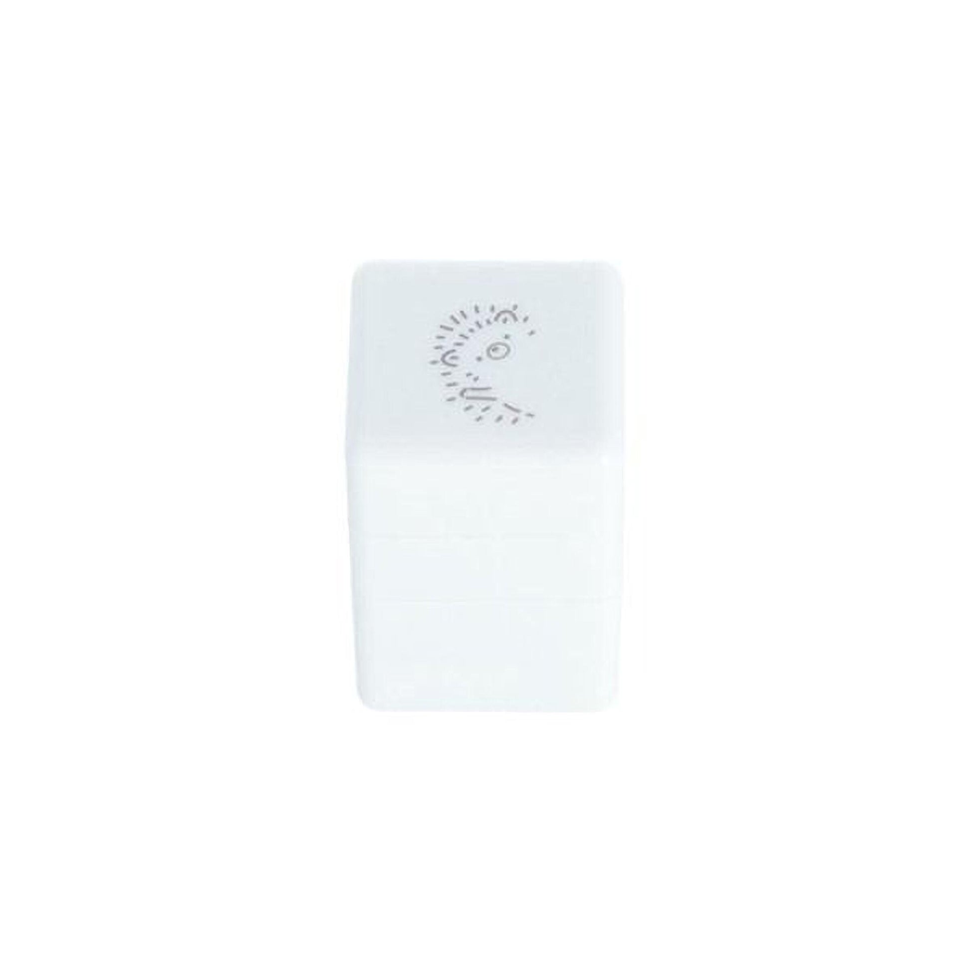 A white rectangular object with a face drawn on it.