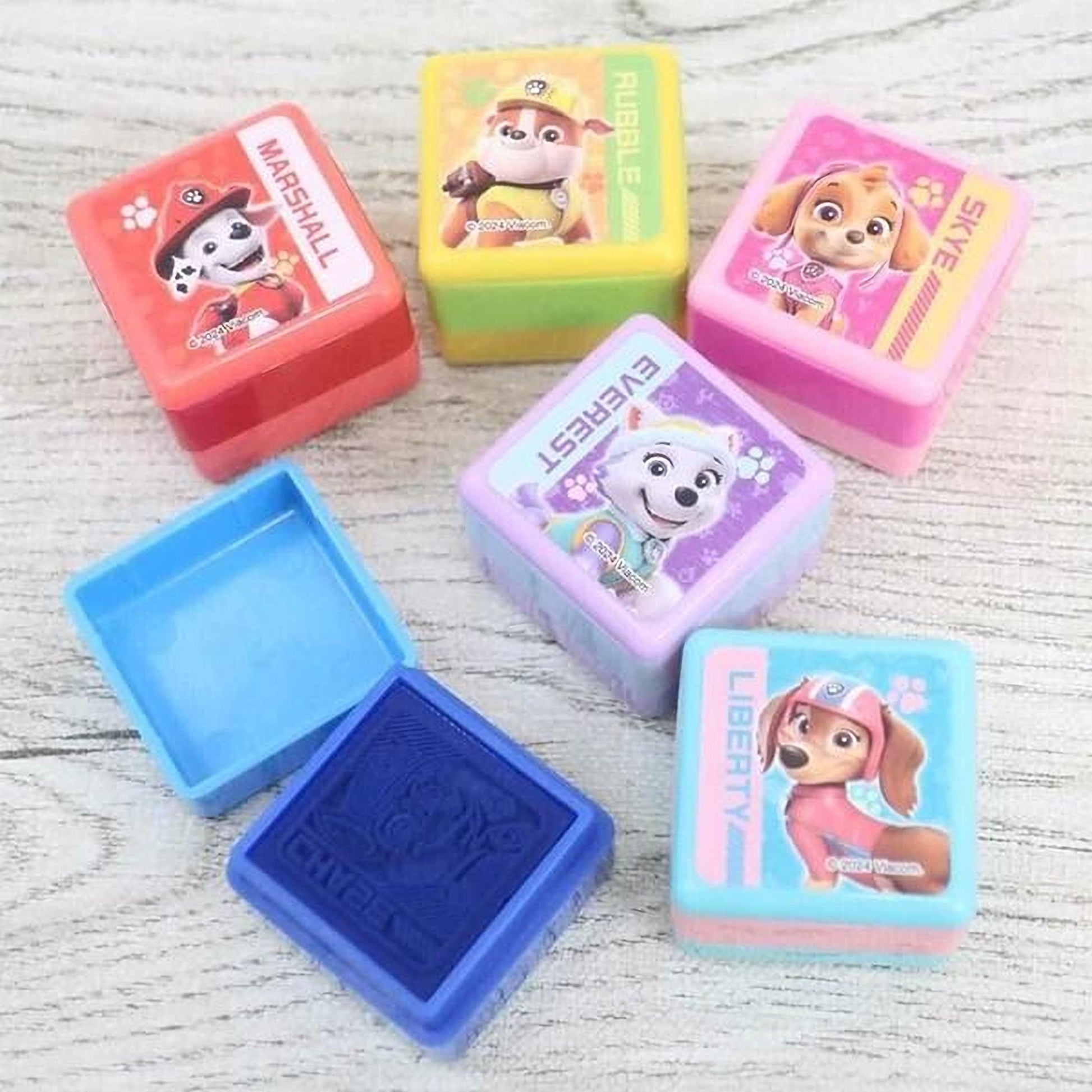 A collection of colorful plastic containers featuring images of the popular children's television show "Paw Patrol".