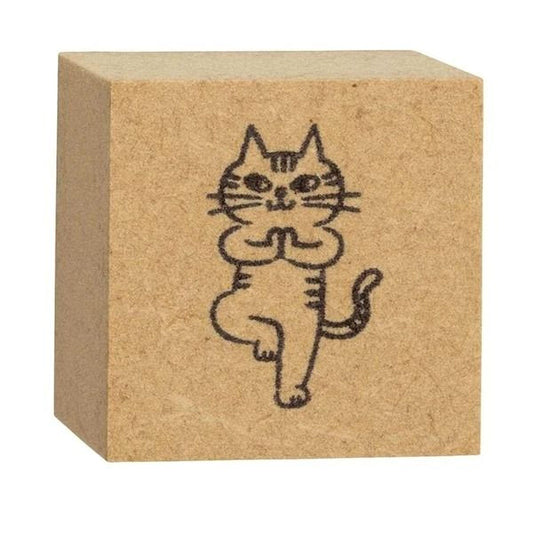 A square wooden block with a simple black line drawing of a cat on it.