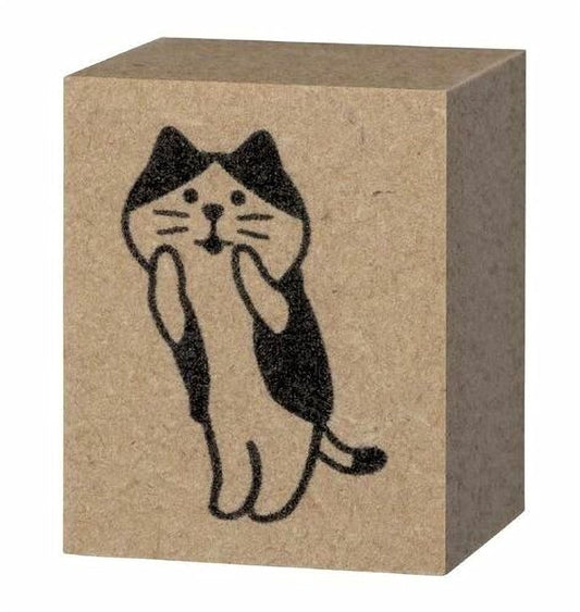 A block of brown cardboard with a black and white illustration of a cat on it.