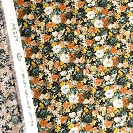 a close-up view of a fabric with a floral pattern, including various shades of orange, yellow, and white flowers. The fabric appears to be a blend of cotton and linen, with a textured and textured appearance.