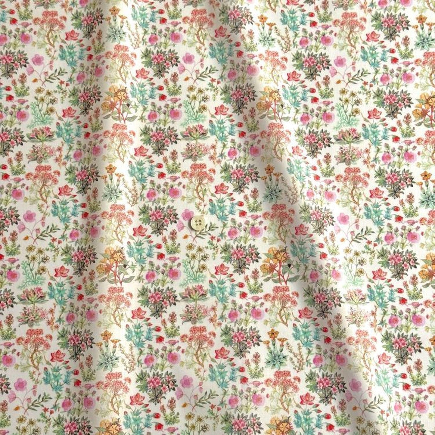a close-up view of a fabric with a floral pattern. The pattern consists of various flowers and plants in different colors, including pink, green, yellow, and orange. The fabric appears to be made of a soft, light-colored material, possibly cotton or linen. The pattern is intricate and detailed, showcasing the craftsmanship and artistry involved in creating the fabric.