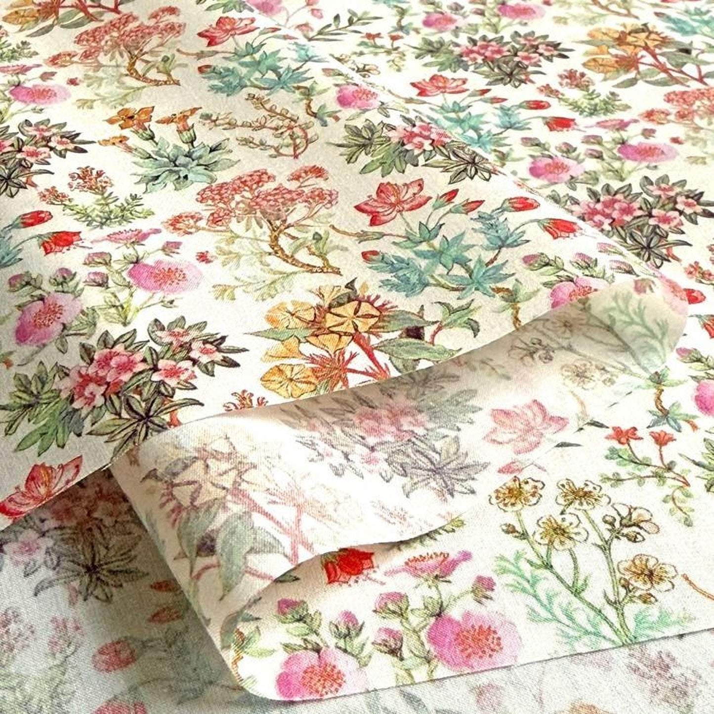a close-up view of a fabric with a floral pattern, showcasing a variety of colorful flowers and leaves.