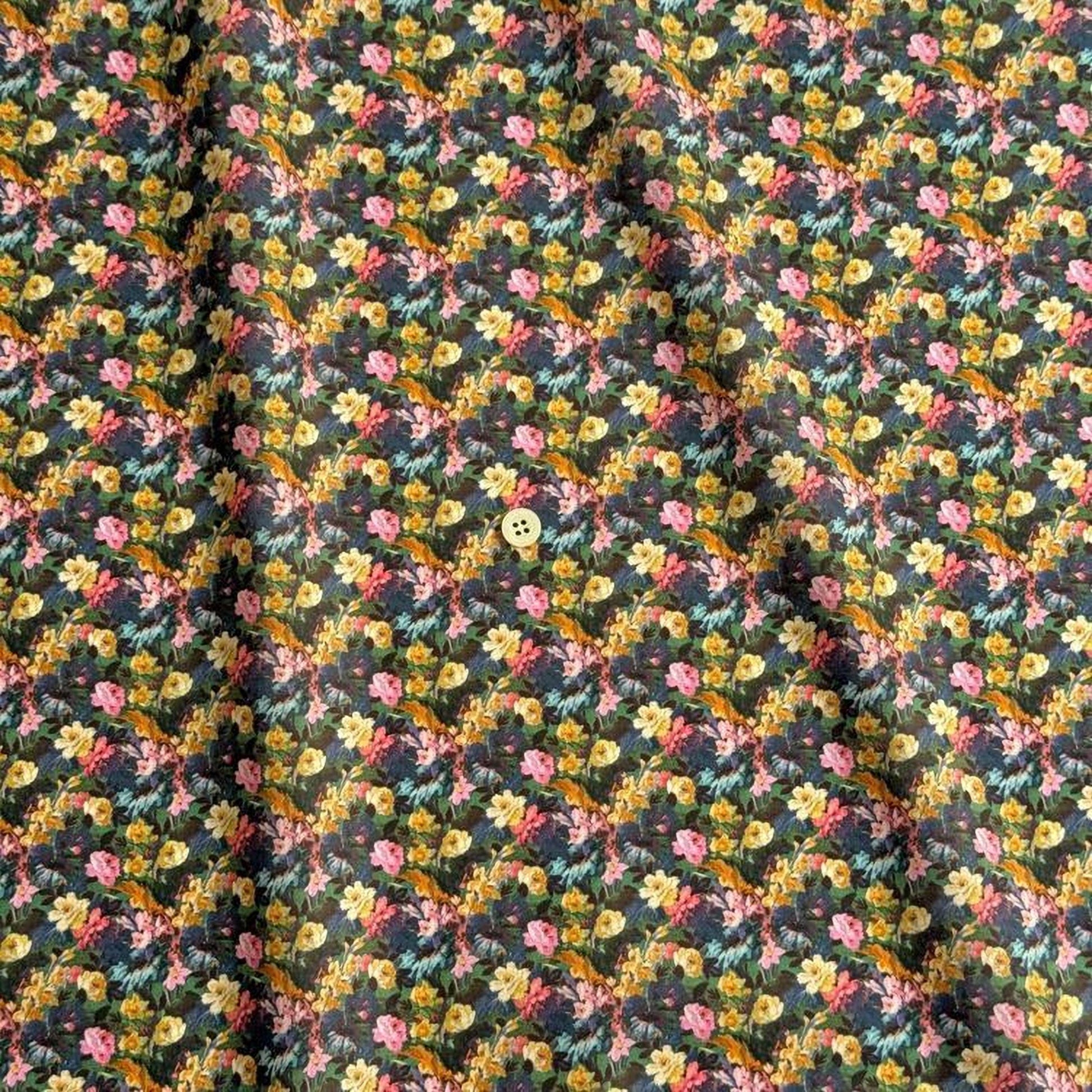 a close-up view of a fabric with a floral pattern, featuring a variety of colorful flowers and leaves.