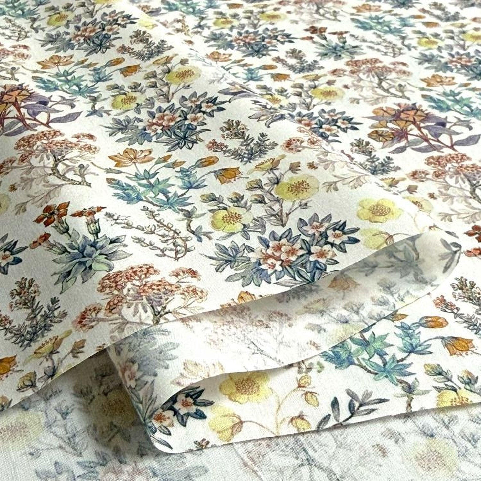a close-up view of a fabric with a floral pattern, showcasing a variety of colorful flowers and leaves.